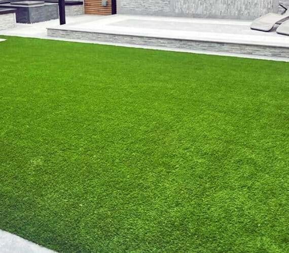Residential backyard with stepping stones and 30mm (Maldives) artificial grass landscaping.